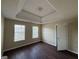 This bedroom has hardwood floors, two windows and a trey ceiling at 257 Juliet Dr, Hampton, GA 30228