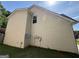 Side view of house showing vinyl siding, greenery, and utilities at 257 Juliet Dr, Hampton, GA 30228