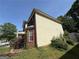 Side view of the house featuring a mix of brick and vinyl siding, complemented by lush landscaping at 257 Juliet Dr, Hampton, GA 30228