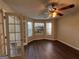 Cozy living room featuring a ceiling fan, wood floors, and bright natural lighting at 257 Juliet Dr, Hampton, GA 30228