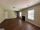 Spacious living room with wood floors, a fireplace, and plenty of natural light at 257 Juliet Dr, Hampton, GA 30228