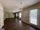 Open-concept living room featuring wood floors, natural light, and convenient access to the backyard at 257 Juliet Dr, Hampton, GA 30228