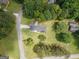 An aerial view displays the house is in a lovely setting on a huge, lush green lot surrounded by old trees at 105 Greenfield Cir, Fayetteville, GA 30215