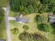 Aerial view of a home with a large yard, mature trees, and a long driveway at 105 Greenfield Cir, Fayetteville, GA 30215