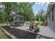 Spacious back patio features a dining area with pergola and manicured flower beds at 105 Greenfield Cir, Fayetteville, GA 30215