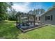 Outdoor patio with a pergola, large table and chairs, with green backyard at 105 Greenfield Cir, Fayetteville, GA 30215