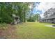 Large grassy backyard with playset, and lush greenery at 105 Greenfield Cir, Fayetteville, GA 30215