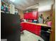 Red cabinets and countertop fill this basement workshop with pegboard and fluorescent lighting at 105 Greenfield Cir, Fayetteville, GA 30215