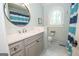 Bathroom features a light blue wall with marble countertop and white tiling at 105 Greenfield Cir, Fayetteville, GA 30215