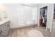 Well-lit bathroom boasts ample storage, natural light, and wood-look flooring at 105 Greenfield Cir, Fayetteville, GA 30215