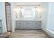 Spacious bathroom with double sink vanity, stone counters, and wood look floors offers ample space at 105 Greenfield Cir, Fayetteville, GA 30215