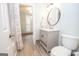 Well-lit bathroom boasts a modern vanity, toilet, and wood-look floors, blending functionality and style at 105 Greenfield Cir, Fayetteville, GA 30215