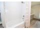 Stylish bathroom features a white tiled shower, modern fixtures, and durable wood-look floors at 105 Greenfield Cir, Fayetteville, GA 30215