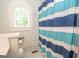 Bathroom featuring a white sink and toilet along with a blue and white shower curtain at 105 Greenfield Cir, Fayetteville, GA 30215