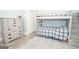 This bedroom features a bunk bed, light blue walls, gray wood floors and two dressers at 105 Greenfield Cir, Fayetteville, GA 30215