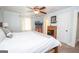 Light-filled bedroom with ceiling fan, white bedding, and neutral walls showcases calming decor at 105 Greenfield Cir, Fayetteville, GA 30215