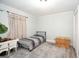 This bedroom features a single bed, wooden floors, and neutral paint at 105 Greenfield Cir, Fayetteville, GA 30215
