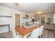 Bright dining room featuring a wooden table with seating for six, and an adjacent living space at 105 Greenfield Cir, Fayetteville, GA 30215