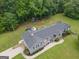 Aerial view of this home showcasing nice landscaping, large lawn and outdoor living spaces at 105 Greenfield Cir, Fayetteville, GA 30215