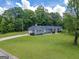 Well-manicured front yard leads to the charming single story home with a long driveway at 105 Greenfield Cir, Fayetteville, GA 30215