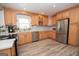 Well-equipped kitchen boasts stainless steel appliances, wood cabinets, and modern countertops at 105 Greenfield Cir, Fayetteville, GA 30215