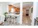 Open kitchen design with stainless appliances, light wood cabinets, and counter seating at 105 Greenfield Cir, Fayetteville, GA 30215