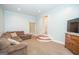 This living room features a brown couch and a TV with a curved step entrance at 105 Greenfield Cir, Fayetteville, GA 30215