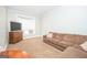 Living room features a large sofa, bay window, flat screen TV and wood dresser at 105 Greenfield Cir, Fayetteville, GA 30215