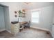 Home office nook with custom desk, shelves and drawers has carpeted flooring and natural light at 105 Greenfield Cir, Fayetteville, GA 30215