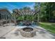 Outdoor patio with a pergola, large table and chairs, and brick fire pit at 105 Greenfield Cir, Fayetteville, GA 30215