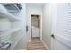 Walk-in pantry with shelving for storage and adjacent laundry area at 105 Greenfield Cir, Fayetteville, GA 30215