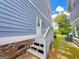 Home's back entrance features a wooden staircase and stone accents on the exterior at 625 Chestnut St # D, Hapeville, GA 30354
