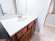 Bathroom featuring a cherry vanity, white countertop and mirror at 625 Chestnut St # D, Hapeville, GA 30354