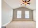 Spacious bedroom with neutral walls, carpet, two windows, two doors, and a ceiling fan at 625 Chestnut St # D, Hapeville, GA 30354