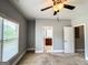 Bedroom with neutral colored walls, carpet, a window with blinds, a ceiling fan, and two doorways at 625 Chestnut St # D, Hapeville, GA 30354