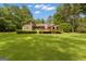 Grassy backyard with mature trees and a fence along the back property line at 105 Gleneagles Pt, Peachtree City, GA 30269