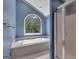 A luxurious bathroom featuring a standalone tub, large window, and a separate glass enclosed shower at 105 Gleneagles Pt, Peachtree City, GA 30269