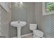 Charming half bathroom with striped wallpaper and pedestal sink at 105 Gleneagles Pt, Peachtree City, GA 30269