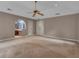Spacious carpeted main bedroom with a ceiling fan, ensuite bath, and walk-in closet at 105 Gleneagles Pt, Peachtree City, GA 30269