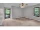 This carpeted bedroom features two windows that offer an abundance of natural light at 105 Gleneagles Pt, Peachtree City, GA 30269