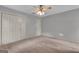 The bedroom features carpeted floors, ample closet space, and a ceiling fan with a light fixture at 105 Gleneagles Pt, Peachtree City, GA 30269