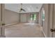 A spacious carpeted main bedroom featuring a high ceiling, a ceiling fan, and a bright window at 105 Gleneagles Pt, Peachtree City, GA 30269