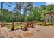 Spacious wooden deck with built in seating overlooking the wooded backyard at 105 Gleneagles Pt, Peachtree City, GA 30269