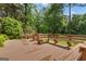 Large wooden deck with built in seating overlooking the wooded backyard at 105 Gleneagles Pt, Peachtree City, GA 30269