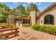 Rear exterior view of the home showing the sunroom and wooden deck with built-in seating at 105 Gleneagles Pt, Peachtree City, GA 30269