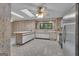 Bright eat-in kitchen with an island, white cabinetry, and modern appliances to provide space for cooking and dining at 105 Gleneagles Pt, Peachtree City, GA 30269