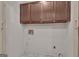Functional laundry room with storage cabinets, utility connections, and space for laundry appliances to increase efficiency at 105 Gleneagles Pt, Peachtree City, GA 30269