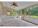 Bright sunroom featuring tile floor, ceiling fan, shiplap, and a view to the backyard at 105 Gleneagles Pt, Peachtree City, GA 30269