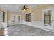 Bright sunroom featuring tile floor, ceiling fan, shiplap, and a view to the backyard at 105 Gleneagles Pt, Peachtree City, GA 30269