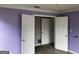 Bedroom with open doors and purple walls, awaiting personal touches to brighten up the space at 621 Ridge Creek Dr, Clarkston, GA 30021